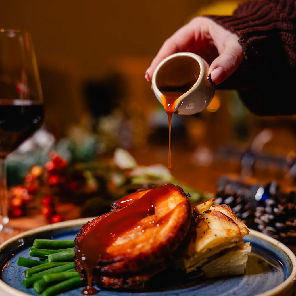 Cranberry Glazed Pork Belly Slow cooked pork belly glazed with cranberry, served with Brussels sprout mash, crispy crackling, Tenderstem broccoli & Gwynt Y Ddraig Orchard Gold Cider jus.
